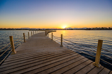  Wooden Pier on Red Sea in Hurghada at sunset, View of the promenade boardwalk - Egypt, Africa