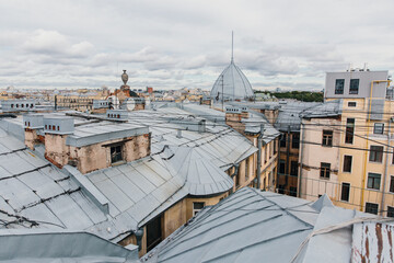 Wall Mural - Iron roofs of houses in the old city. Top view of rainy St. Petersburg.