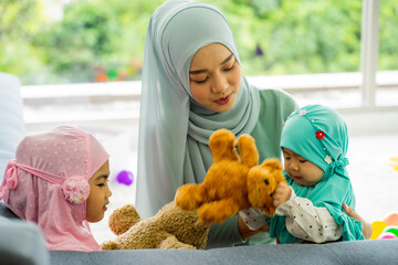  muslim woman mother wearing HIJAB green work from home and caring baby daughter and girl. in the house.