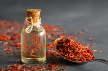Glass Bottle Of Saffron Essential Oil On Rustic Background, Spice Or Herb Oil Concept, Alternative Medicine (Crocus Sativus)