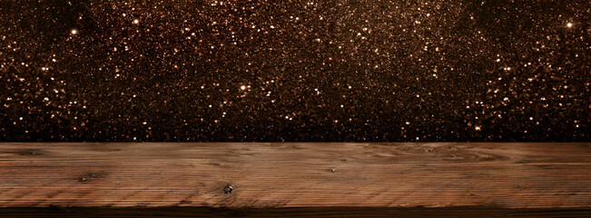 Aufkleber - Glitter background with table
Dark abstract glitter background in front of empty wooden table. Festive golden blurry panoramic banner for christmas and new year with space for design and text.