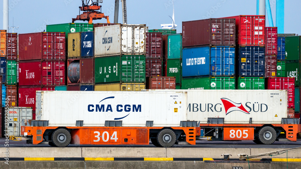 Automated Guided Vehicles transporting shipping containers at a ...