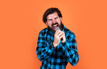 brutal bearded man rock singer singing a song in microphone at karaoke, rock music