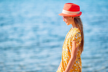 Wall Mural - Adorable little girl at beach during summer vacation