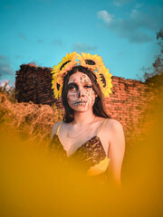 Sticker - Young female with artistic spooky makeup and sunflower on head posing at the camera in a field