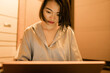 © Pansfun Images/Stocksy - young woman using laptop