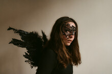 Attractive Mysterious Woman In Black Outfit And Mask With Wings Like Dark Fallen Angel