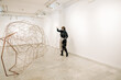 © Aleksandra Jankovic/Stocksy - Female Sculptor Carrying A Piece Of A Complex Metal Sculpture