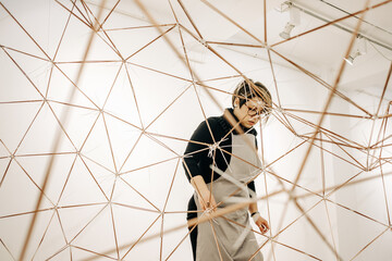 Woman Artist Working On An Abstract Metal Sculpture
