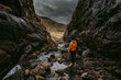 © Chris Zielecki/Stocksy - Male hiker exploring mountain ravine with river