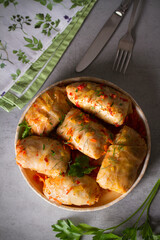 Wall Mural - Cabbage rolls with meat, rice and vegetables. Chou farci, dolma, sarma, golubtsi or golabki. Flat lay, layout, overhead