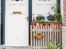 White Door With Wooden Gate And Spring Flowers