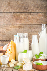 Wall Mural - Set of Various Fresh Dairy Products - milk, cottage cheese, cheese, eggs, yogurt, sour cream, butter on wooden background