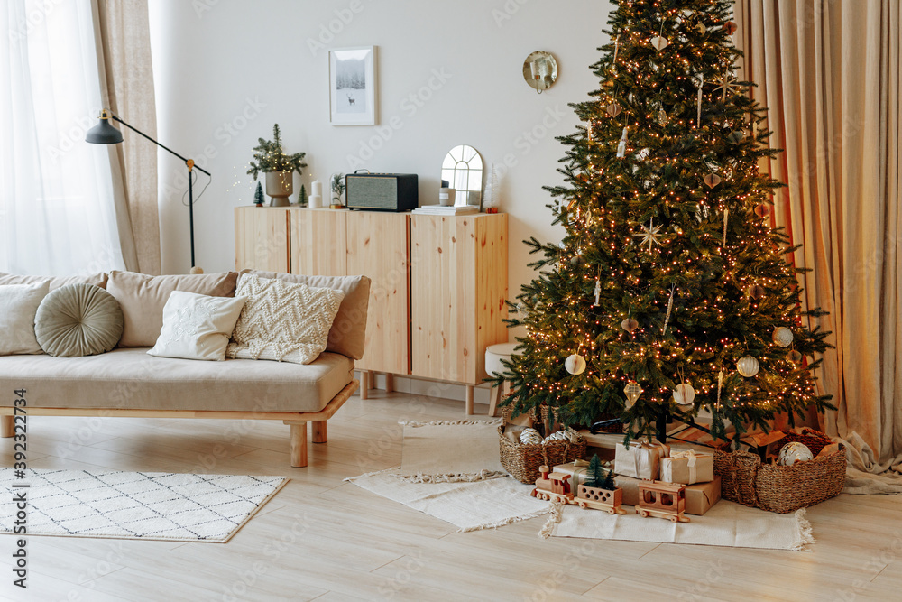 Bright interior of the living room with a sofa and a large Christmas ...