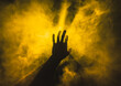 © Ivan Andrianov/Stocksy - hand touches yellow smoke