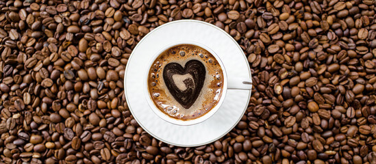 Banner.Cafes and restaurants. A mug of invigorating, black coffee with heart shaped foam and coffee beans in a bag on a white background. Place for an inscription. The concept of hot drinks and love.