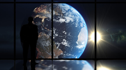 man looking at planet earth through a window