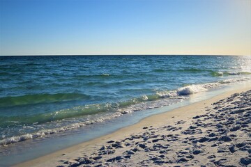 Wall Mural - Evening landscape, sunset on the beach, calm ocean view, bright sunlight and blue sky