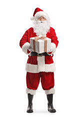 Wall Mural - Full length portrait of Santa claus holding a big present box