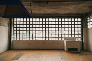 Canvas Print - Square small windows and worn ceiling and floor inside a building