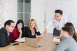 © Nawarit - Business people brainstorming ideas for solving problems in company meeting rooms, the company staff meeting.