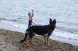 © Angelina - Little girl playing on the beach with her big dog