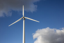 Closeup Shot Of A Single Windmill For Electric Power Production With A Cloudy Sky Behind