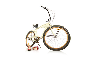 Poster - Closeup of a bicycle and red heels isolated on a white background