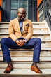 © Mocha Stock - Portrait of confident African American businessman in glasses and tan blazer.