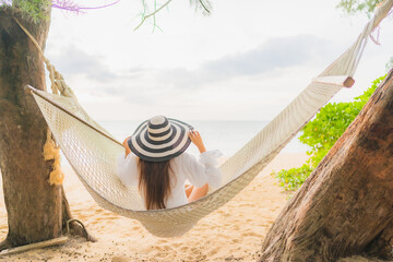 Wall Mural - Portrait beautiful young asian woman relax on hammock around beach sea ocean