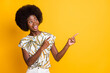 © deagreez - Photo of optimistic nice curly hair lady point empty space wear print t-shirt isolated over yellow color background
