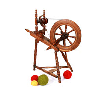 Closeup Shot Of An Old Wooden Spinning Wheel With Balls Of Yarn Isolated On White Background