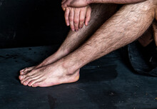 Male Bare Feet In A Calm Position On A Black Background