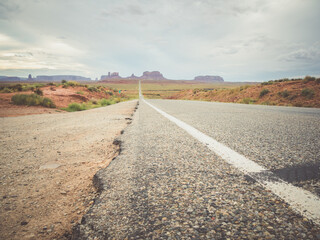 Wall Mural - Beautiful view of rocky cliffs under a cloudy sky in Monument Valley, Utah, USA