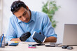 © Elnur - Young male technician repairing mobile phone