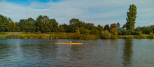 Man Swimming On Yellow Kayak On Odra River