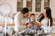 © Vadim Pastuh - Young family near festive table in the kitchen