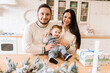 © Face Stock - Young family near festive table in the kitchen