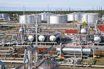 Large Oil Industrial Facility, equipment, pipelines, tanks with oil products, utilities.