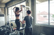 © P Stock - Woman exercise with trainer man in the gym.
