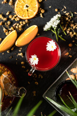 Fruit hot tea with the addition of oranges, lemons, mandarins and raspberries in a glass cups on a table. Healthy hot drink. tea with fruit and berries in a glass teapot. tea for colds.