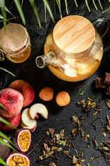 Fruit hot tea with the addition of oranges, lemons, mandarins and raspberries in a glass cups on a table. Healthy hot drink. tea with fruit and berries in a glass teapot. tea for colds.