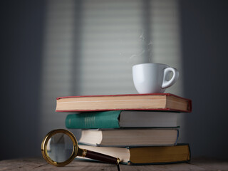 Wall Mural - Stack of books, espresso cup and magnifying glass