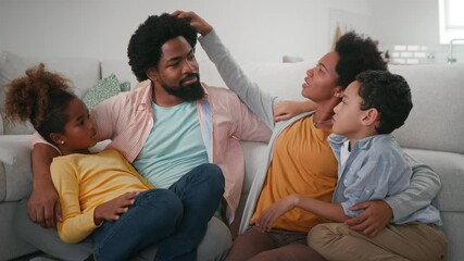 Wall Mural - Afro family of four hanging at home. Woman comparing hair of her husband with sons hair.