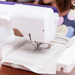 Woman works at an embroidery machine