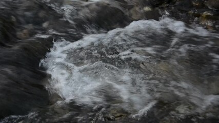 Wall Mural - A small waterfall on a mountain river.