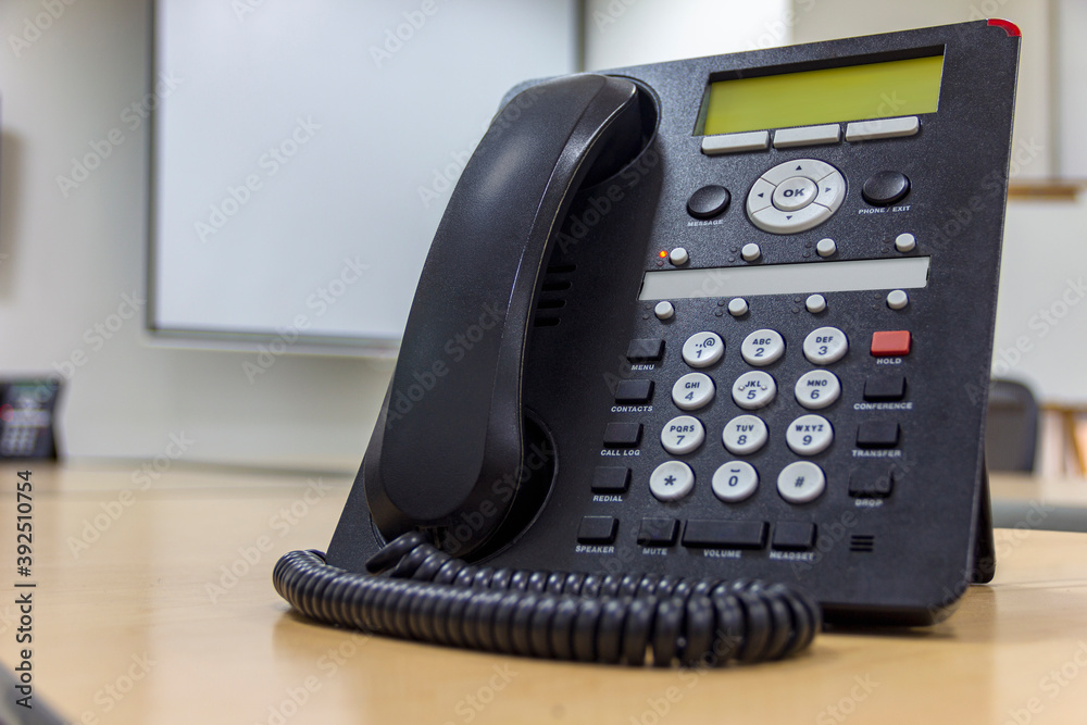 Conference table with office telephone in the foreground, office switch ...