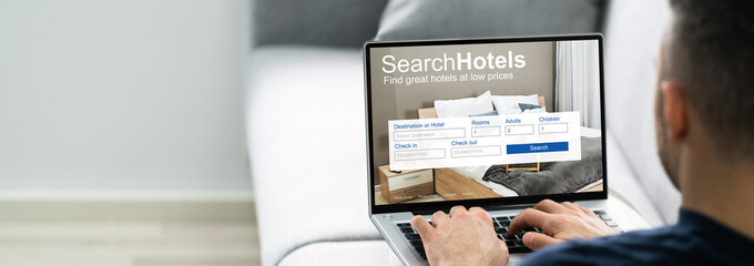 Man Booking Hotel Online At Home