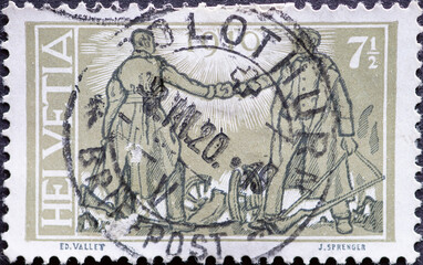 Wall Mural - Switzerland - Circa 1919 : a postage stamp printed in the swiss showing a handshake by two soldiers. Occasion peace treaty