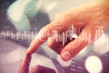 Multi exposure of man's hands holding and using a phone and financial chart drawing. Market analysis concept.